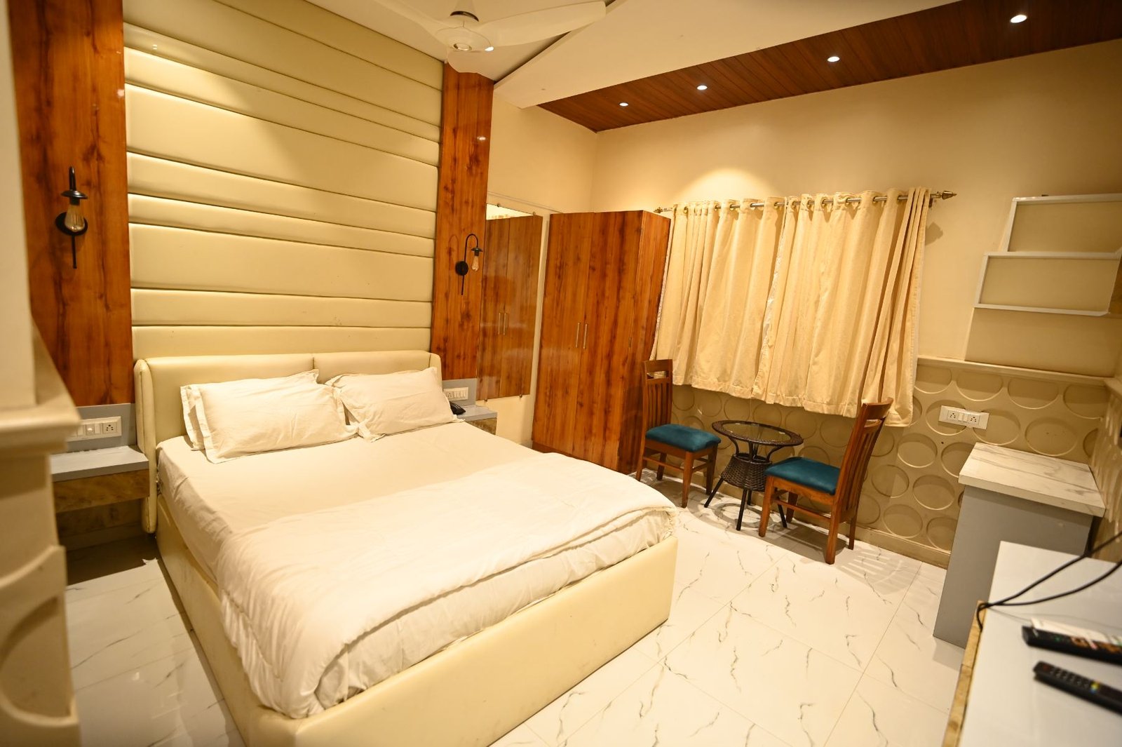Deluxe room with window seating and wardrobe at Palm Springs Beach Resort, Borivali West Mumbai