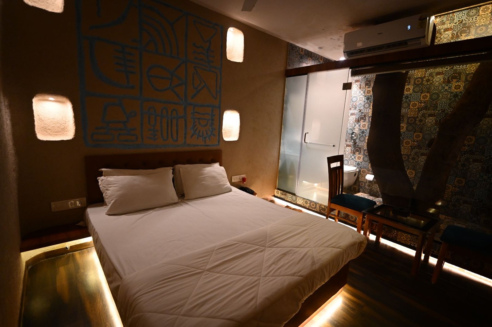 Bed and handworked blue mural in Nature's Vault at Palm Springs Beach Resort, Gorai Beach Road Mumbai