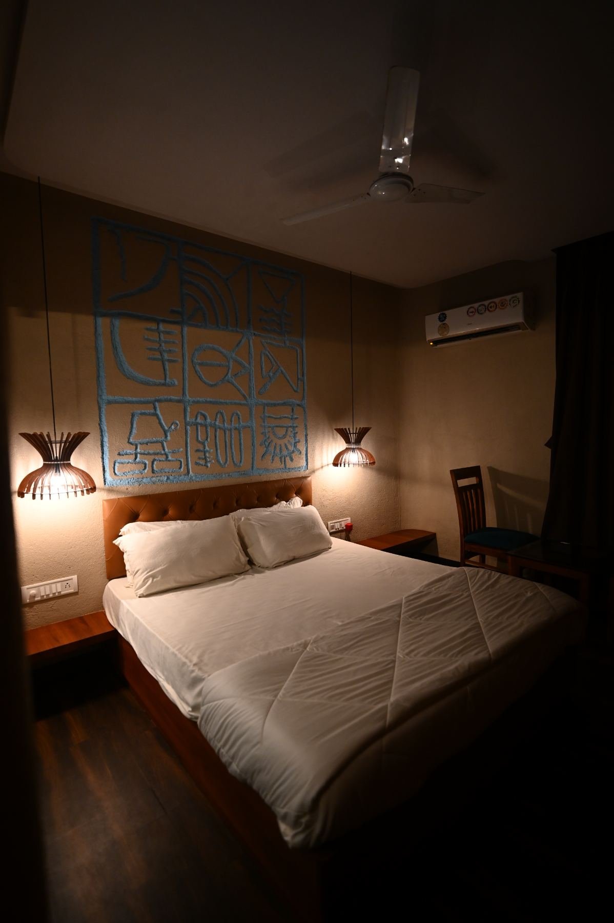 Semi Deluxe room at Palm Springs Beach Resort Gorai with ochre plaster walls and pendant lighting