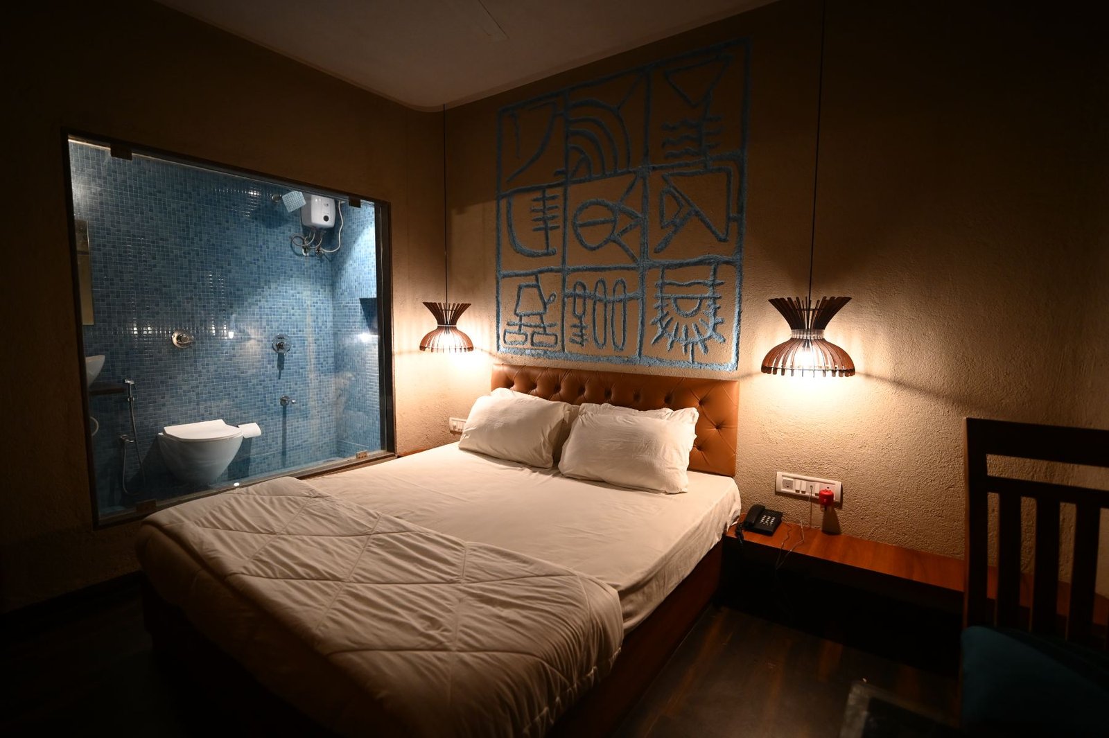 Semi Deluxe bedroom and glass walled mosaic bathroom at Palm Springs Beach Resort, Gorai